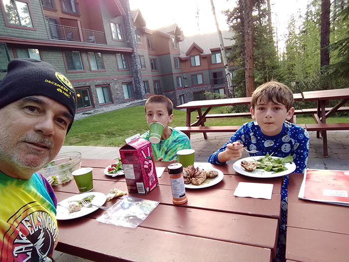 The Thomas family enjoys Luke's grilled chicken dinner in Canmore (Banff Canada)